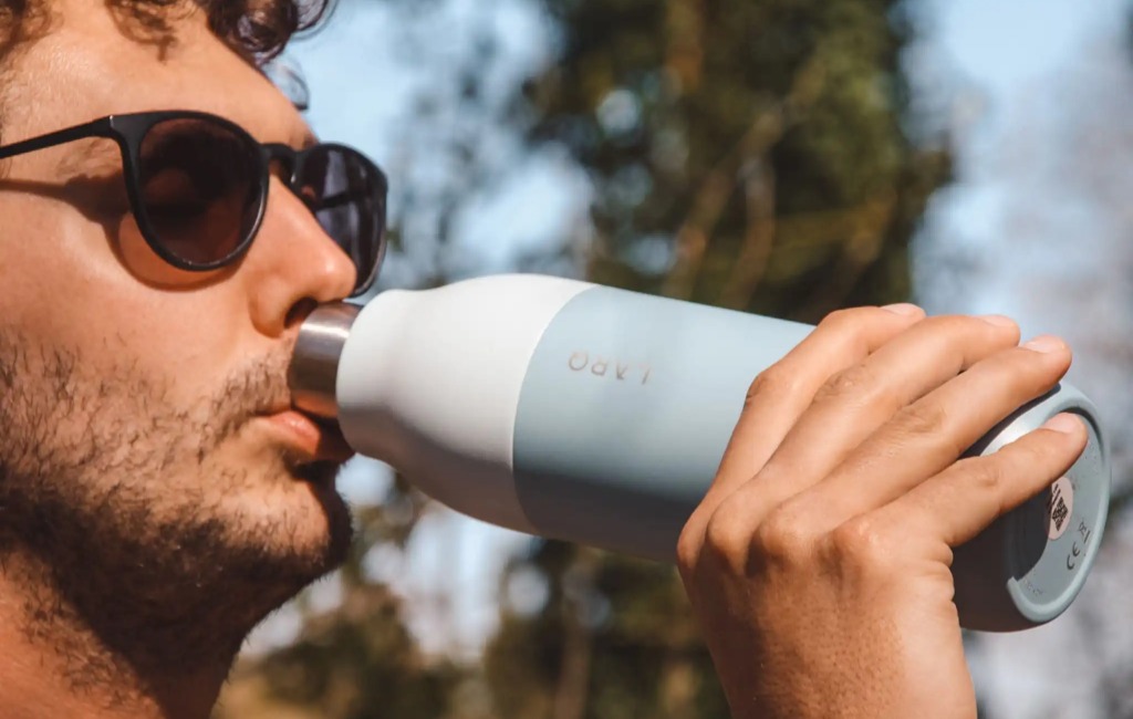 drinking from larq self-cleaning water bottle