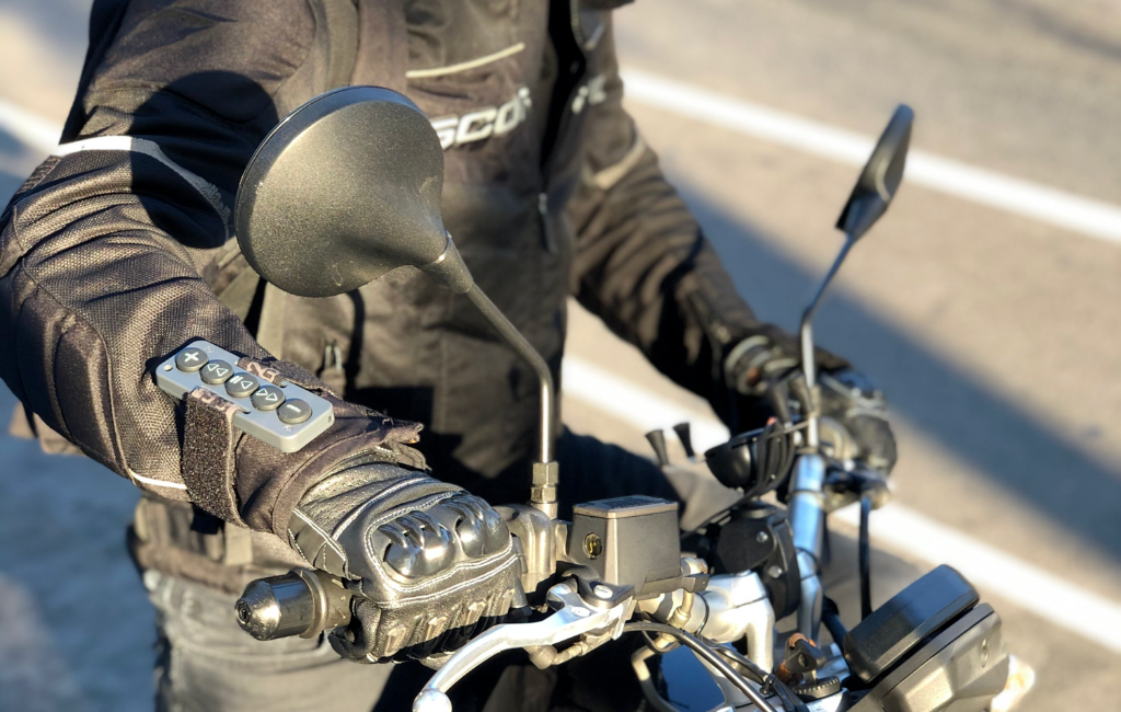 a biker wearing chubby buttons bluetooth remote on arm