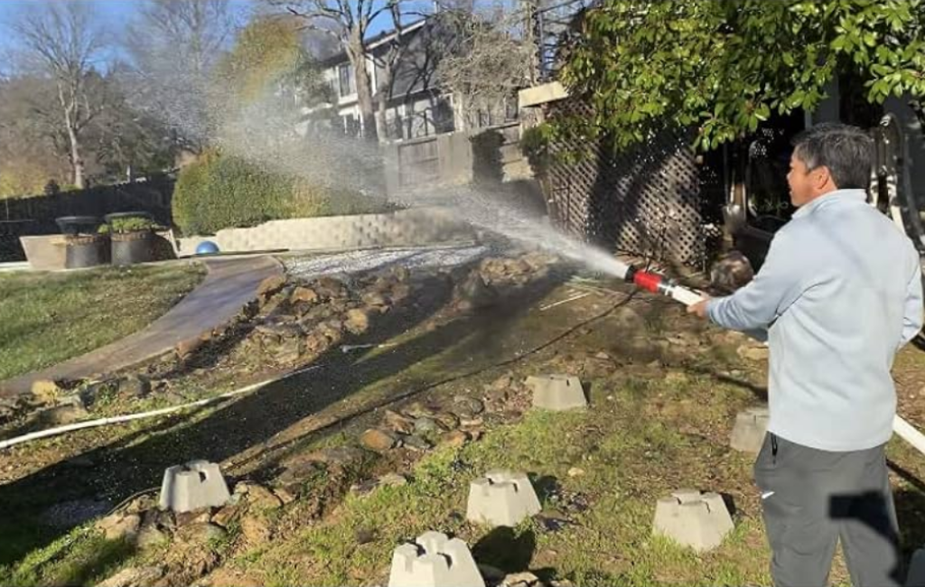 a man using firefighter1 fire hose