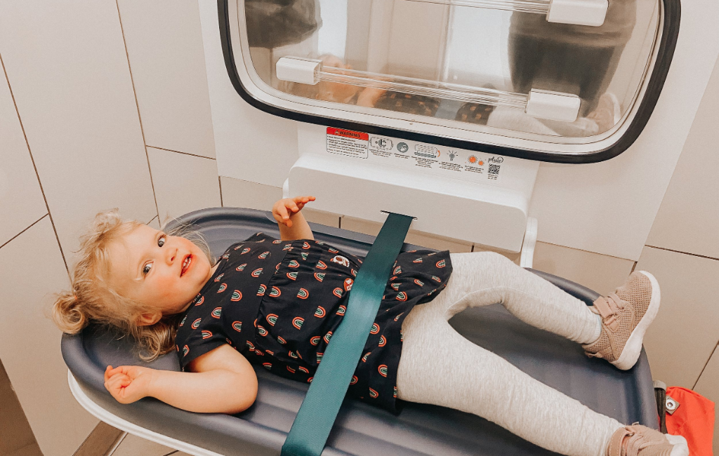 a baby laying on pluie diaper changing table