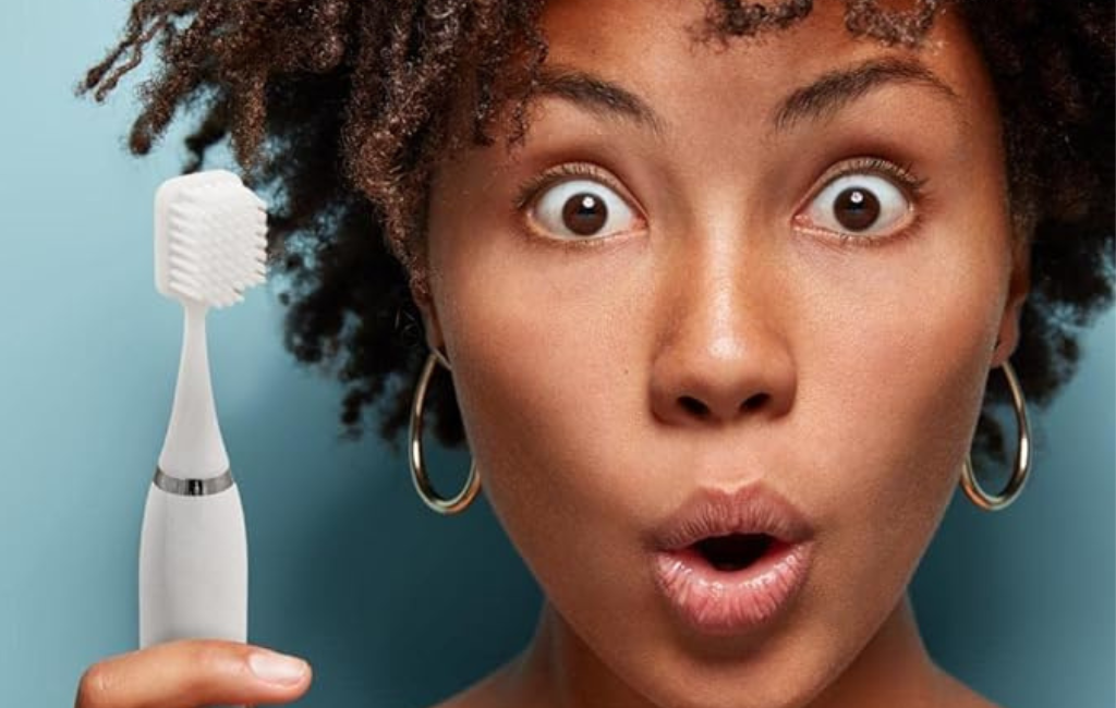 a girl holding big mouth toothbrush in white