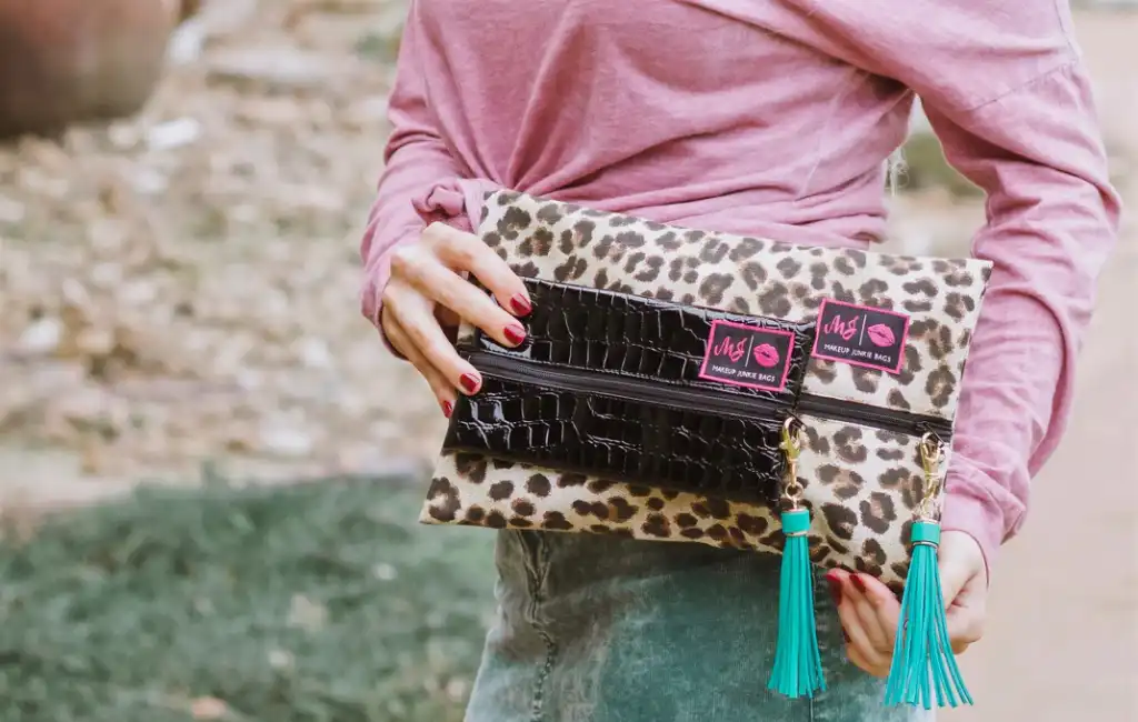 woman holding makeup bag