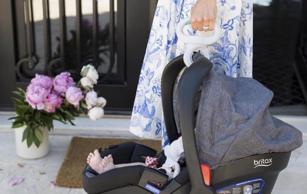 woman holding baby carrier