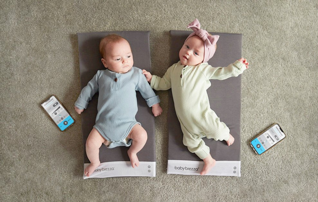 babies lying on mats