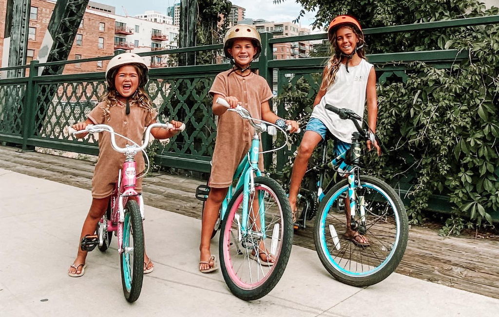 kids driving bikes on bridge