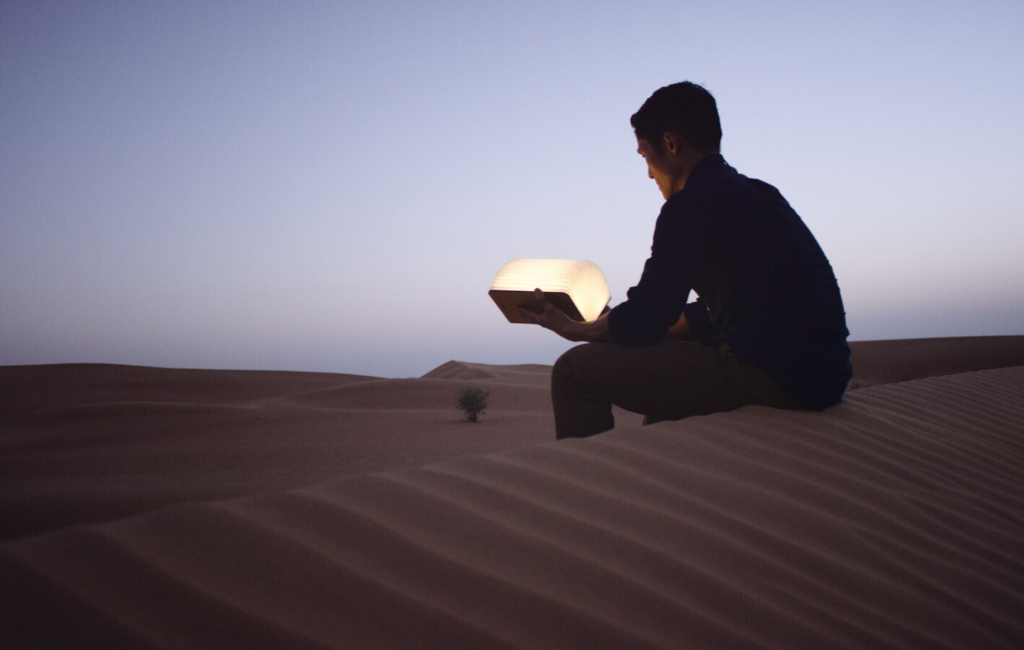 man-holding-lamp-desert