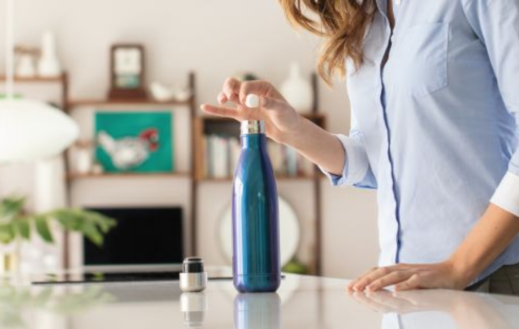 adding tablet in bottle