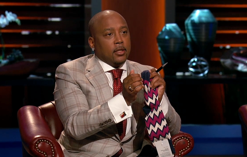 daymond-john-holding-foot-cardigan-socks