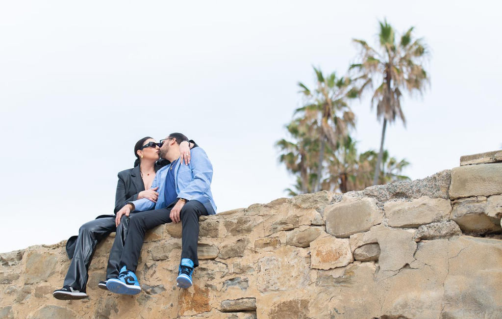 happy-engaged-couple-on-wall