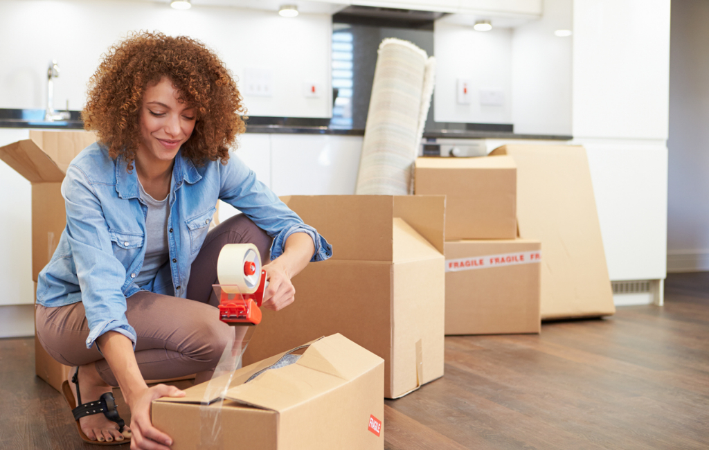 Woman-taping-up-boxes